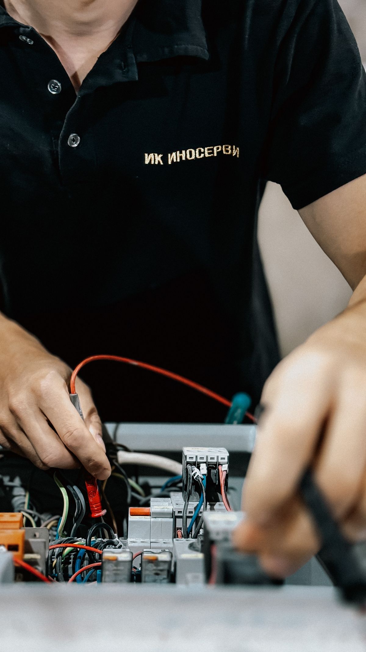 Master electrician performing precise electrical work