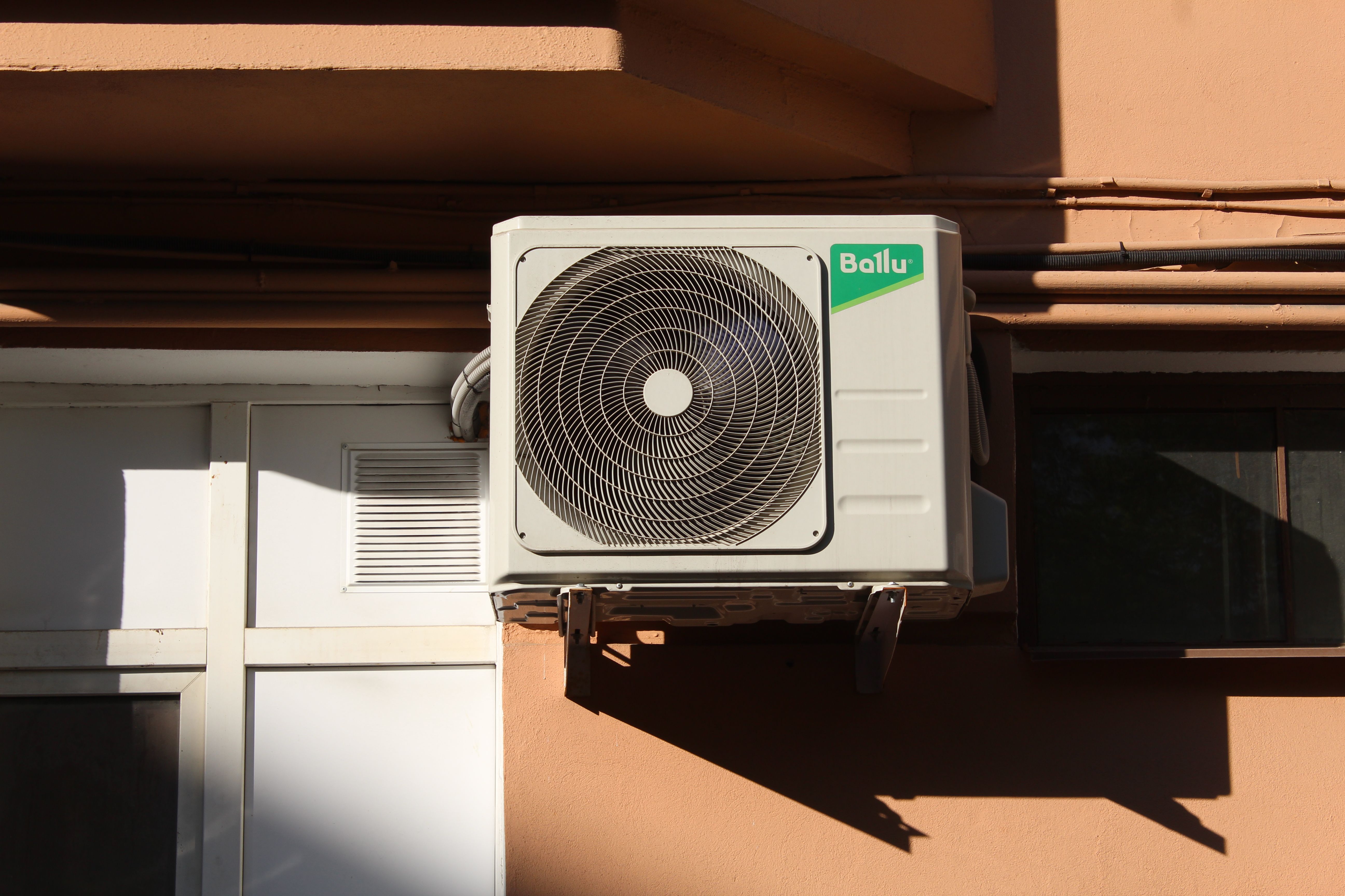 Saguaro technician installing a condenser unit on a Phoenix home