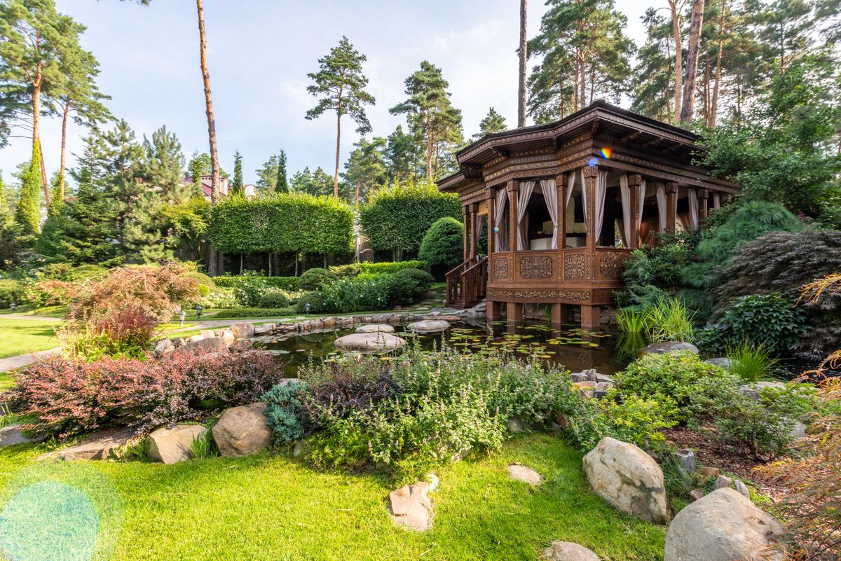 Garden water feature with gazebo and lush planting